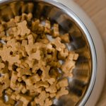 Dog biscuits in a stainless steel bowl