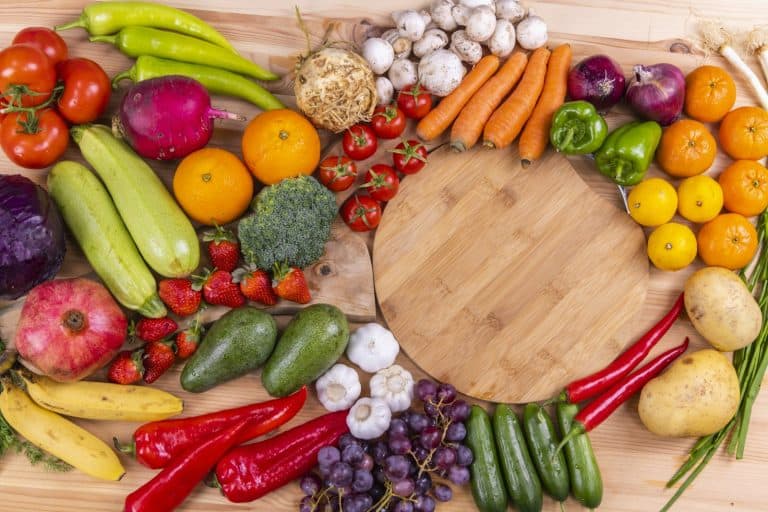 Fresh fruits and vegetables arranged on a board